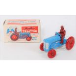 A Moko Products scale model of a tractor finished in red and blue with dark red driver figure,