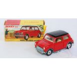 A Dinky Toys No. 183 Morris Mini Minor comprising of red and black body with spun hubs and cream