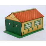 A Dinky Toys pre-war No. 45 garage, comprising of cream walls with orange roof and detailed tin