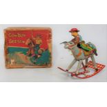 A CK Toys of Japan tinplate and clockwork model of a cowboy seesaw comprising of cowboy seated on