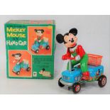 An MT/Masudaya of Japan tinplate battery operated model of Mickey Mouse on hand car, comprising of