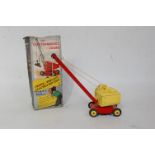 A DCMT No. 121 4-wheel Electro Magnetic Crane comprising of red and yellow body with yellow hubs and