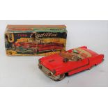 A KO Toys of Japan No. 8435 tin plate and battery operated model of a U-turn Cadillac, finished in