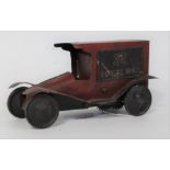 A circa 1920s tin plate and clockwork Royal Mail delivery van comprising red and black body with red
