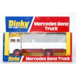 A Dinky Toys No. 940 Mercedes Benz truck, comprising of white and red body with grey plastic canopy,
