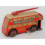 A Brimtoy tin plate and clockwork double decker trolley bus comprising of red body with detailed