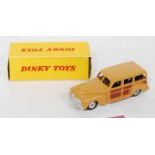 A Dinky Toys No. 344 estate car comprising of tan and brown body with spun hubs and M tyres in the