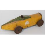 An unusual early 20th century model of a tin plate and clockwork racing car comprising of yellow and
