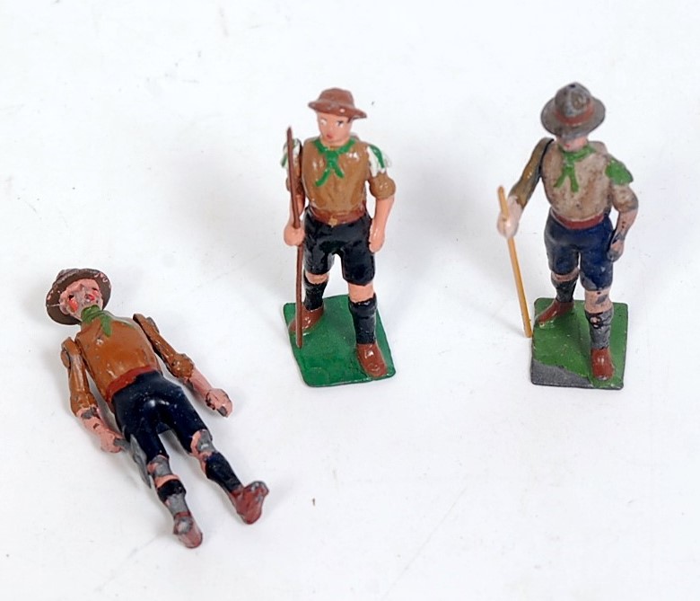 Three various loose Britains boy scout figures to include boy scout standing with axe, two walking