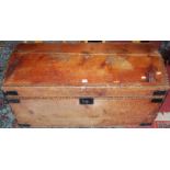 A 19th century stained pine, brass studded and further metal bound domed hinge top travelling trunk,