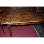 A joined elm refectory dining table, having twin frieze drawers and raised on square tapering