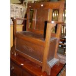 An early 20th century panelled oak box seat stick/stand settle, width 73.5cm