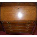 A circa 1800 provincial oak slopefront writing bureau, having a fitted interior over four long