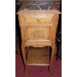 A circa 1900 provincial French walnut and rouge marble inset single door pot cupboard, having single