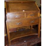 An early 20th century oak slopefront writing bureau, having twin short drawers over single long