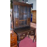 An antique oak narrow dresser, the top having open plate racks, twin cupboard doors over kneehole