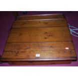 A stained and planked pine table top slopefront hinged writing ledger, width 61cm