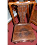 A pair of early 19th century provincial elm and oak floral relief carved splatback panelled seat