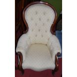 A mid-Victorian mahogany framed and floral buttoned upholstered spoonback scroll armchair, width