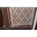 Two Caucasian red ground rugs, together with a further European woollen rug (3)