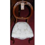 A pair of mid-Victorian walnut balloon back salon chairs