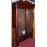 A Victorian mahogany and flame mahogany double door glazed bookcase of good size, having single long