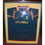 A framed South African rugby shirt, signed by Schalk Burger and Sup(?) Burger
