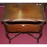 An early 20th century mahogany shaped top low occasional table, having four sided hinged platforms