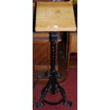 A Gothic style black painted wrought iron and oak lectern, the stand of spiral twist and scroll