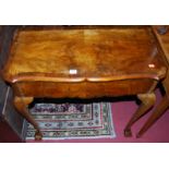 An early Georgian style figured walnut and cross banded serpentine front single drawer side table,