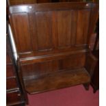 An unusual joined, planked and four panelled oak wing back settle, width 122cm