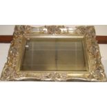 A reproduction silvered composition moulded wall mirror, 81 x 106cm