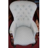 A mid-Victorian mahogany framed and blue floral button back upholstered armchair, width 67cm