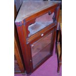 A late Victorian mahogany single door glazed hanging corner cupboard (lacking top surface)