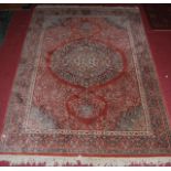 A Persian style machine woven red ground rug 200x140cm; together with two other smaller similar