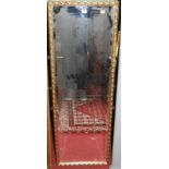 A gilt framed and bevelled rectangular wall mirror, 124 x 41cm