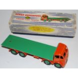 A Dinky Toys No.902 Foden flat truck, comprising second type cab, finished in orange with orange