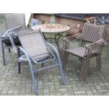 A contemporary patio suite comprising; circular tile inset table and four stacking elbow chairs,