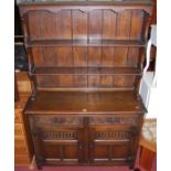 A 17th century style joined and moulded oak dresser, having two-tier open plate rack, the twin
