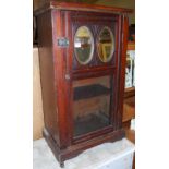 An Edwardian walnut single door mirrored and glazed music cabinet