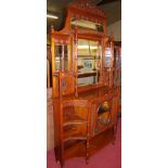 A late Victorian walnut floral relief carved and bevelled mirror back side cabinet, the four