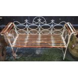 A contemporary white painted wrought metal two seater folding garden bench, having rolled arms,