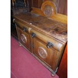 An Edwardian oak ledgeback sideboard, having twin ovolo shaped frieze drawers over conforming