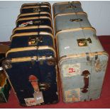 Two wooden bound cabin trunks, with gilt metal fittings and some traces of luggage labels