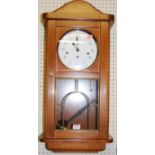 A contemporary beech Lowell Westminster chime drop trunk wall clock, with pendulum and key