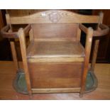 An early 20th century oak hinge top combination stick/stand settle, width 92cm