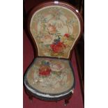 A Victorian mahogany framed and floral needlework tapestry upholstered nursing chair