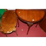 A figured walnut topped coffee table; together with a demi-lune side table (2)