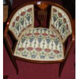 An Edwardian mahogany satinwood inlaid and further strung tub chair, upholstered in stylised