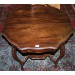 An Edwardian stained walnut octagonal shaped top occasional table, dia.74cm